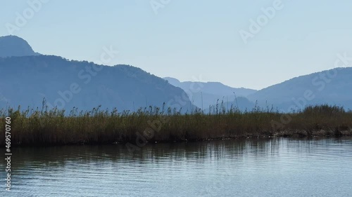 The picturesque bay of Ekinchik in Turkey, near one of the many islands near Fethye, fishing boats, mountains on background photo