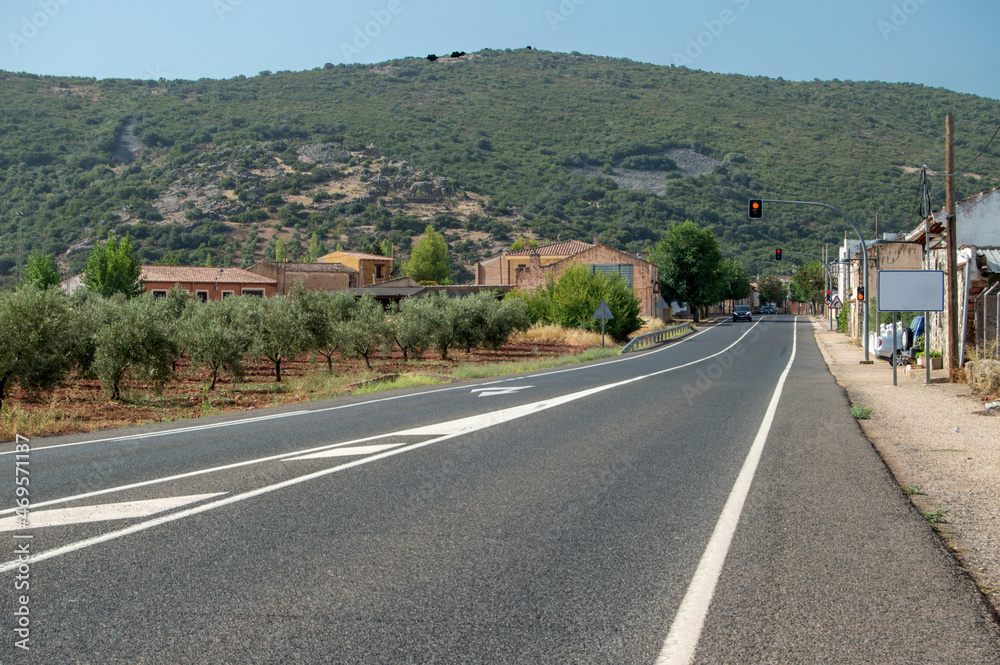 landscape with a country road leading to a hill In Castilla La Mancha. Spain