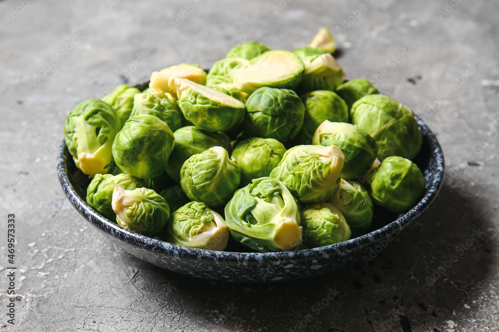 Bowl with raw ripe Brussels cabbage on grey background Bowl with raw ripe Brussels cabbage on grey background