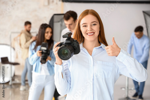 Happy female photographer during classes in studio