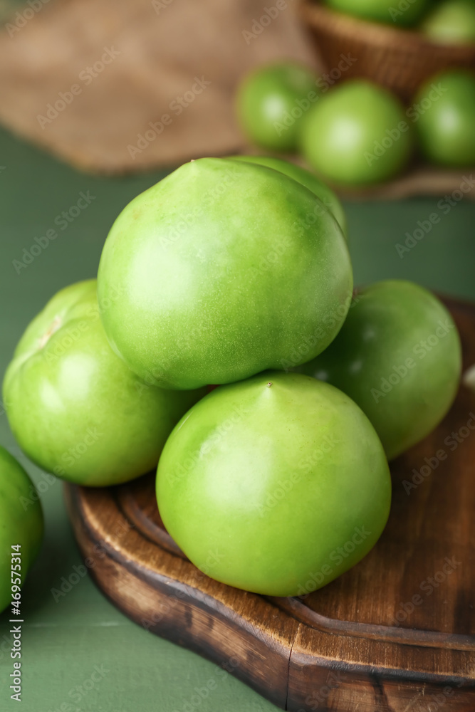 Board with fresh tomatoes on green wooden background Board with fresh tomatoes on green wooden background