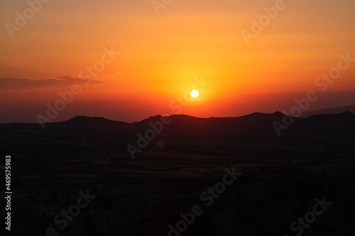 Sunset over the mountains. Sunset scene with silhouettes of mountains