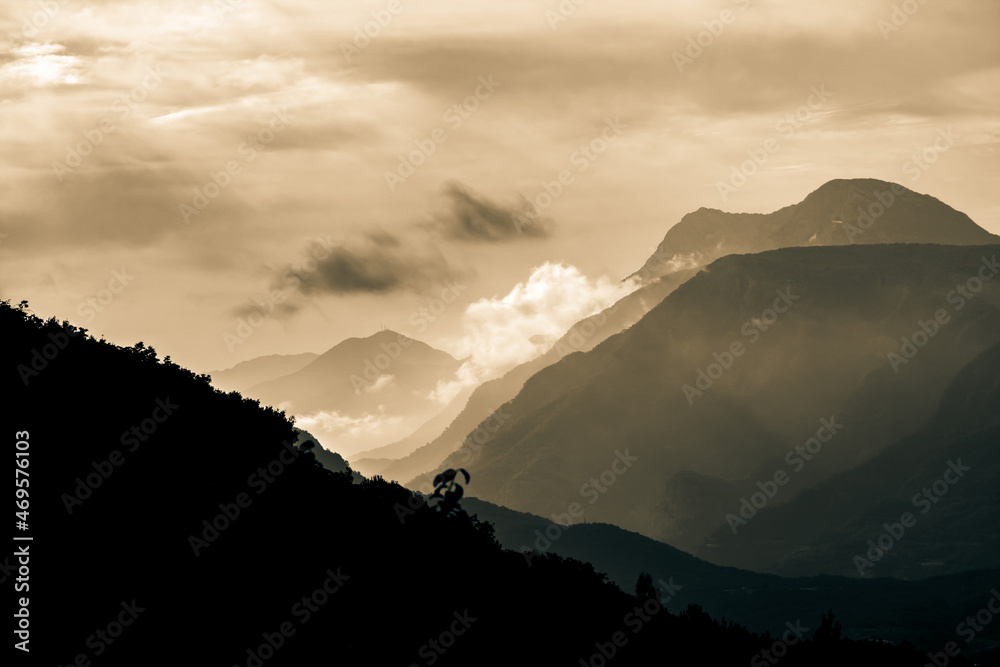 Mountain peaks. Sepia mountain silhouettes with mist and fogs.