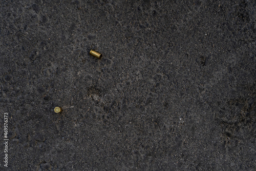 Two different caliber bullet shell casings on asphalt street
