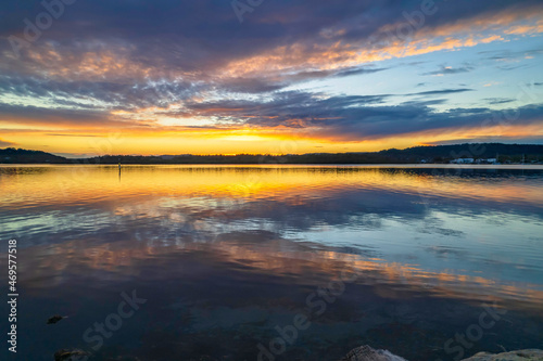 Sunrise aerial waterscape over the bay with cloud cover