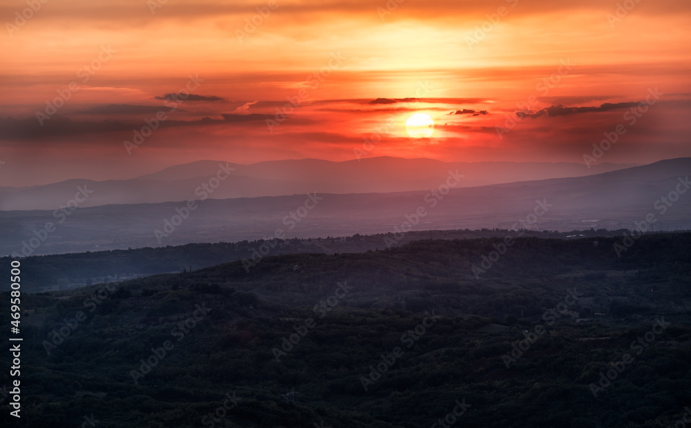 Sunset with layers of hills and mountains, soft focus. Mountain layers in sunset. Blue mountains and last sun lights landscape. Sunset with layers of hills and mountains, soft focus. Mountain layers in sunset. Blue mountains and last sun lights landscape.