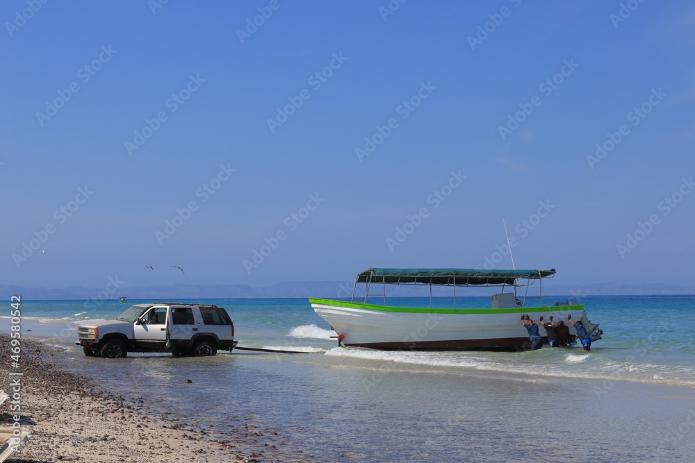 Fototapeta premium Trying to get a boat out of the water