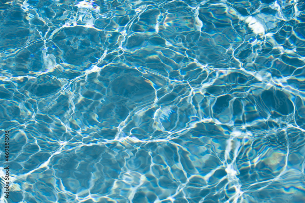 Fototapeta premium Background of blue water in swimming pool with sun reflection, ripple water wave in pool. Clear water background.