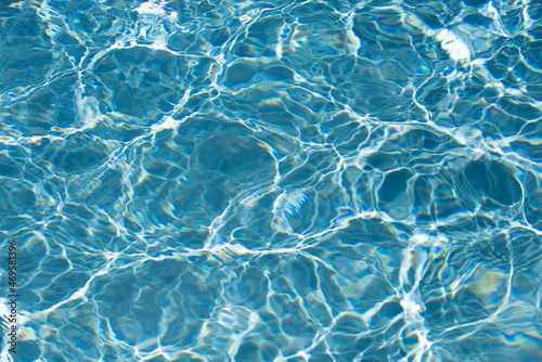 Background of blue water in swimming pool with sun reflection  ripple water wave in pool. Clear water background.