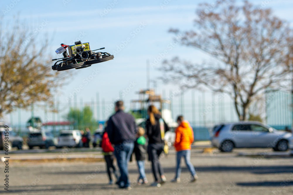 Mini drone flying in the park near people Mini drone flying in the park near people
