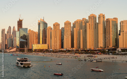 Dubai Marina Skyscrapers at Sunset. The golden hue of sunset bathes the impressive skyscrapers of Dubai Marina  showcasing the architectural prowess of the city
