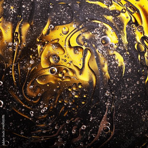 Abstract space surreal yellow black golden background, oil bubbles in water
