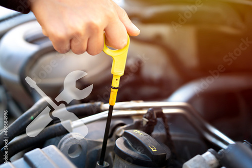 to check car engine oil, using engine oil check stick with maintenance logo