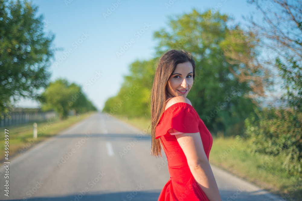 A girl in a red dress on the road A girl in a red dress on the road