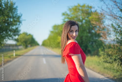 A girl in a red dress on the road