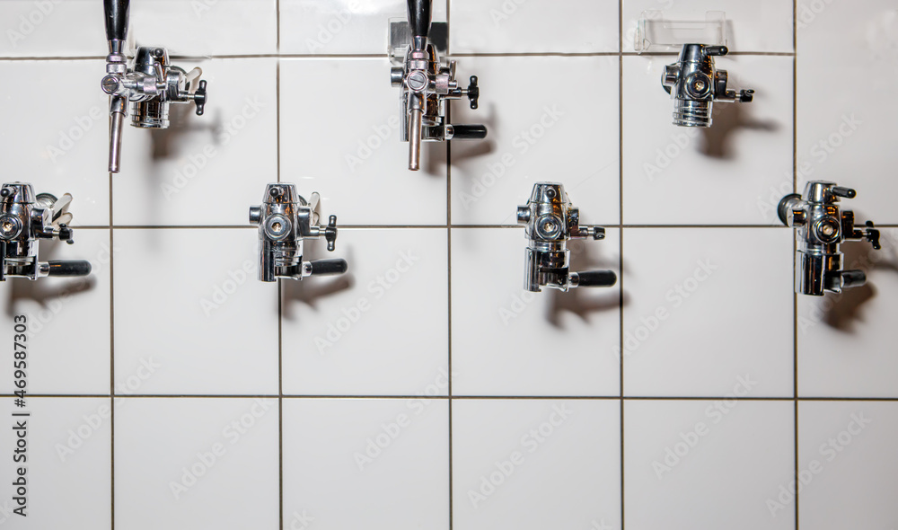 Taps in the wall for pouring beer into plastic dishes. Taps in the wall for pouring beer into plastic dishes.