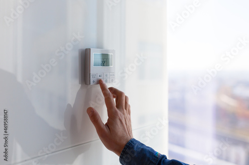 The air conditioning and heating control panel for the apartment and office is located on a white wall photo