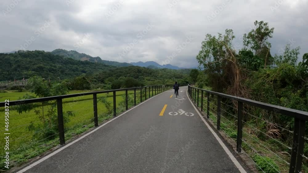 action camera clip of riding a bicycle with one cyclist in front in nature scenic region with bicycle track action camera clip of riding a bicycle with one cyclist in front in nature scenic region with bicycle track