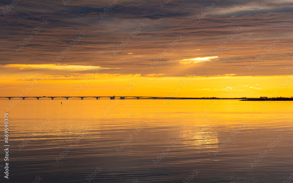 The Zeeland Bridge is the longest bridge in the Netherlands. Her seen during sunset The Zeeland Bridge is the longest bridge in the Netherlands. Her seen during sunset