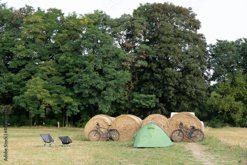 Cyclists Camping behind hay bales in a field, Rechlin, Germany photo
