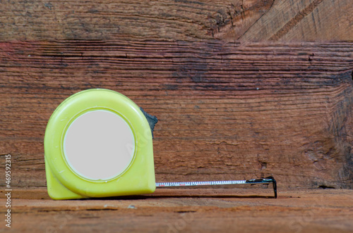 Roulette. Measure the length. Roulette on a wooden background