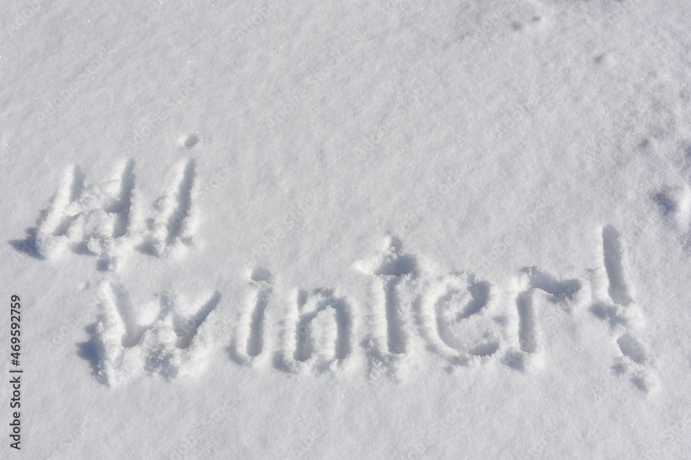 Inscription Hi Winter, written on white background of the snow. Top view. Flat lay. New Year concept Inscription Hi Winter, written on white background of the snow. Top view. Flat lay. New Year concept