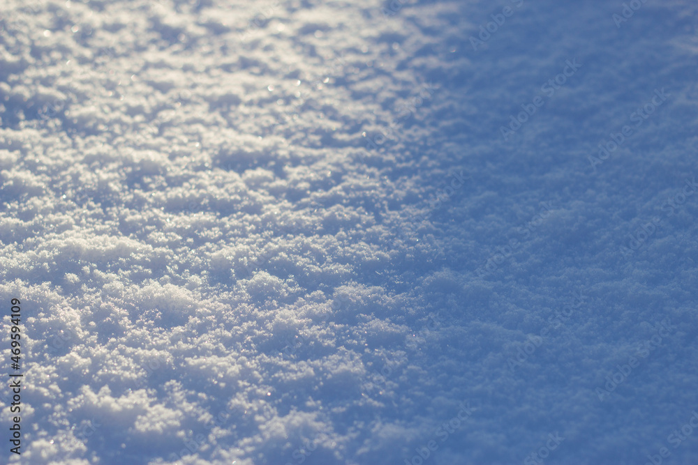 snow textured surface with cold blue shadow and shining cristals