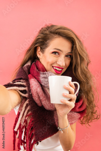 Portrait of beautiful girl holding Cup and taking picture.