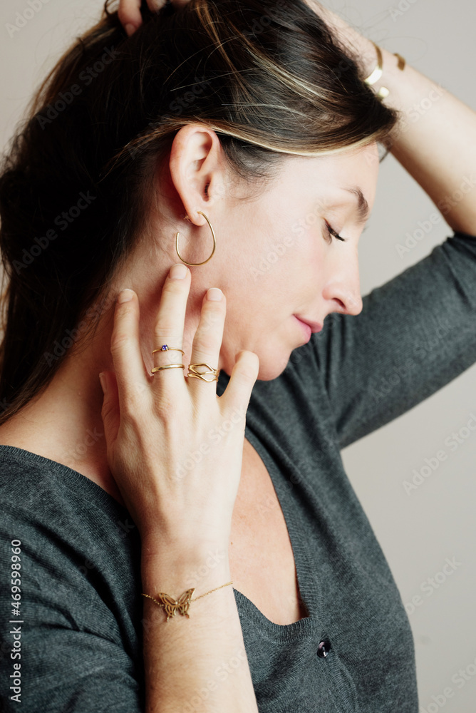 Caucasian woman posing with gold jewelry. Studio portrait of model with jewelry. Caucasian woman posing with gold jewelry. Studio portrait of model with jewelry.