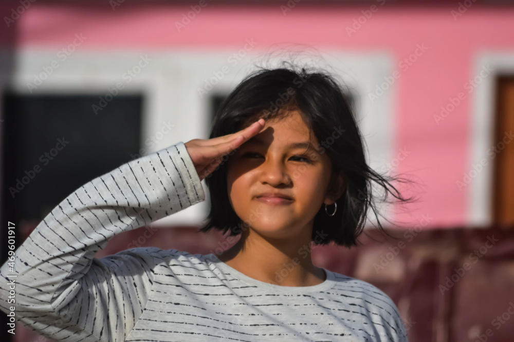 a beautiful young girl performing a military salute. a beautiful young girl performing a military salute.