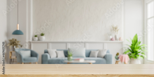 Wood table top on blur living room have sofa and armchair. © Vanit่jan