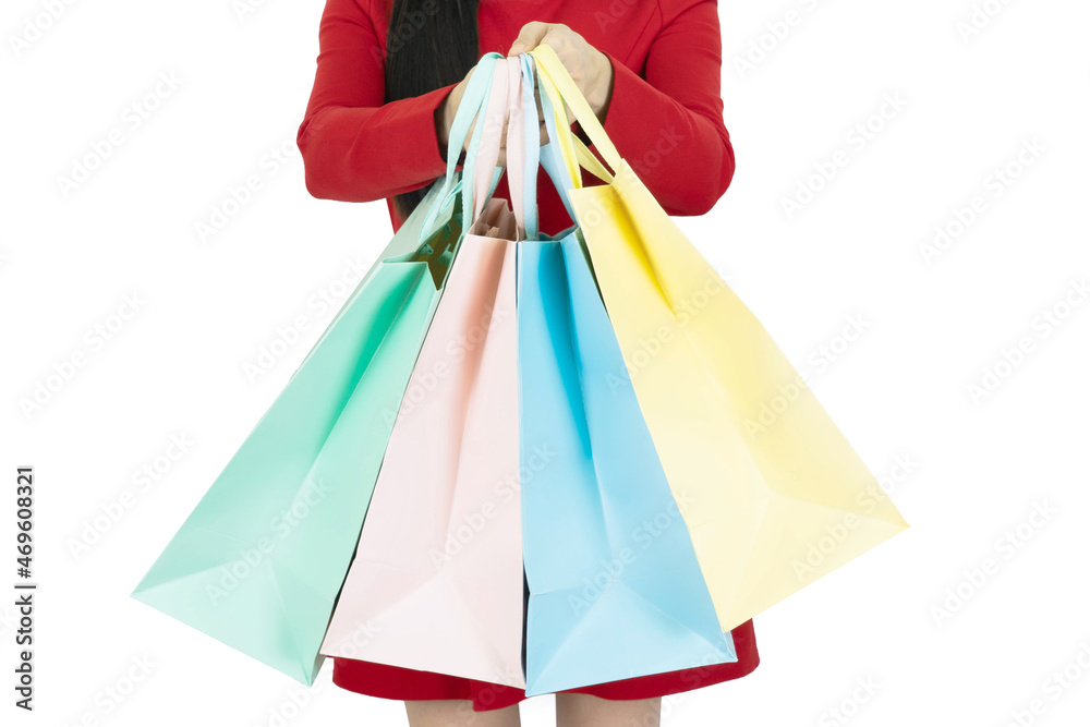 Cropped view of young woman in red coat holding colorful shopping bags isolated on white, closeup.Huge sale, seasonal discounts, sale and fun.