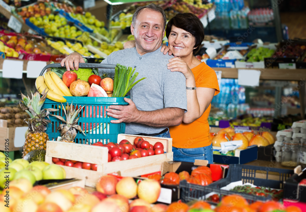 Portrait of family couple who is standing in the grocery shop