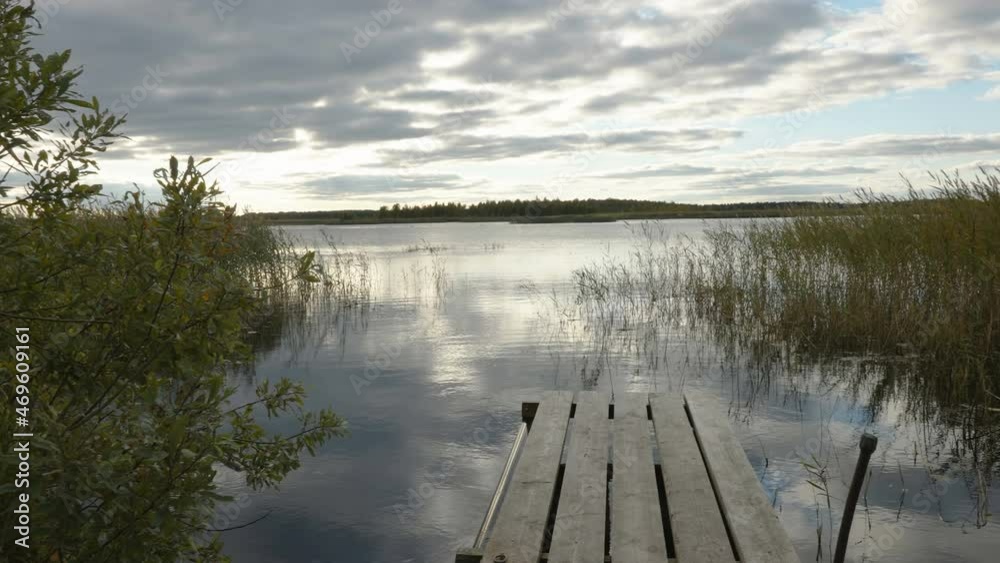 Landscape view of the river in the forest with the wooden ledge on the center in Estonia Landscape view of the river in the forest with the wooden ledge on the center in Estonia