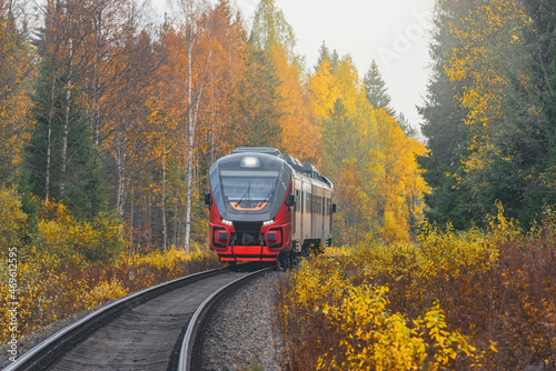 Passenger diesel local train moves to Sortavala at autumn day time. Karelia. Russia.