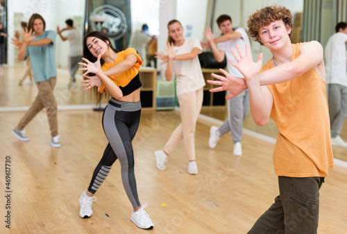 Young boys and girls performing contemporary dance in studio.