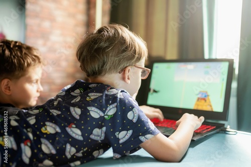 6 year old boy online gaming in the domestic room photo