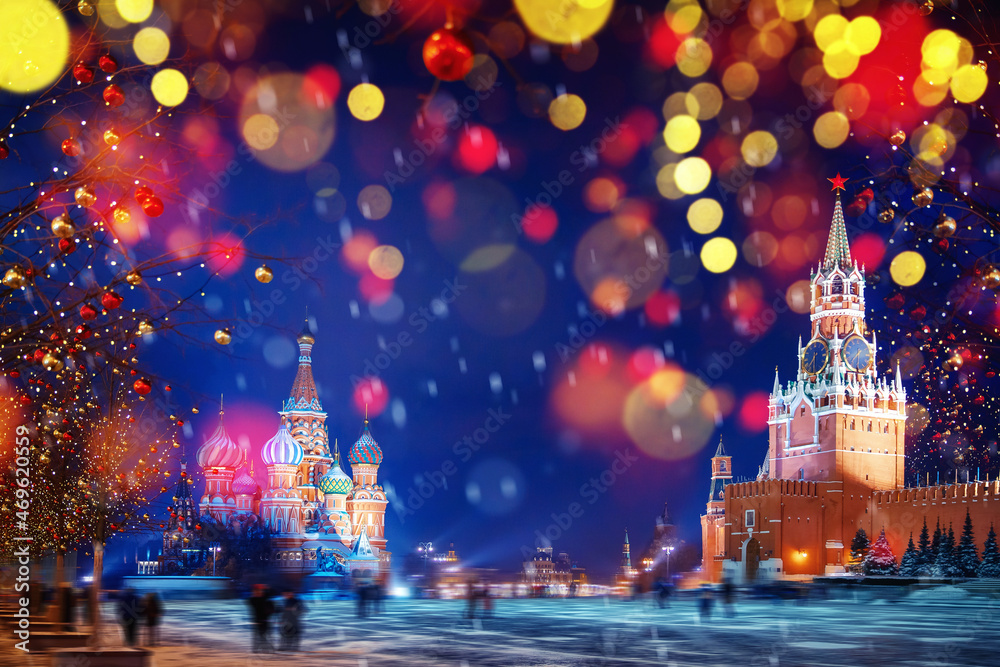 Winter night light Moscow Red square with snow. Christmas Russia holidays St Basils Cathedral new year background bokeh