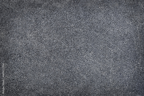 Black colored granulated material texture asphalt close up top view black background