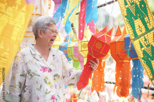 asian old elderly elder woman with hanging festive paper lantern