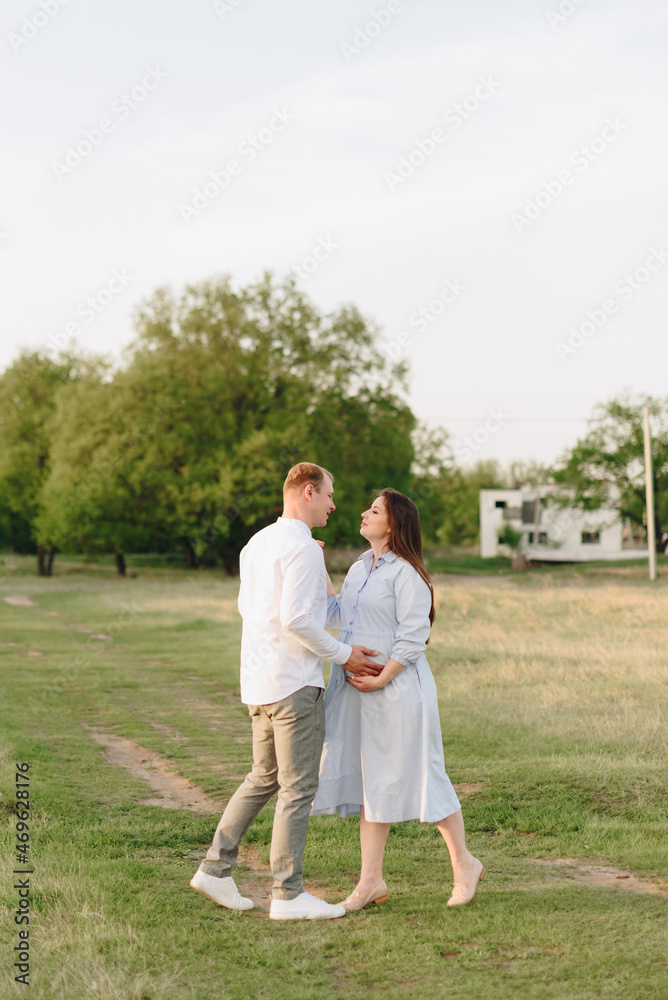 Young heterosexual pregnant couple in an outdoor park Young heterosexual pregnant couple in an outdoor park