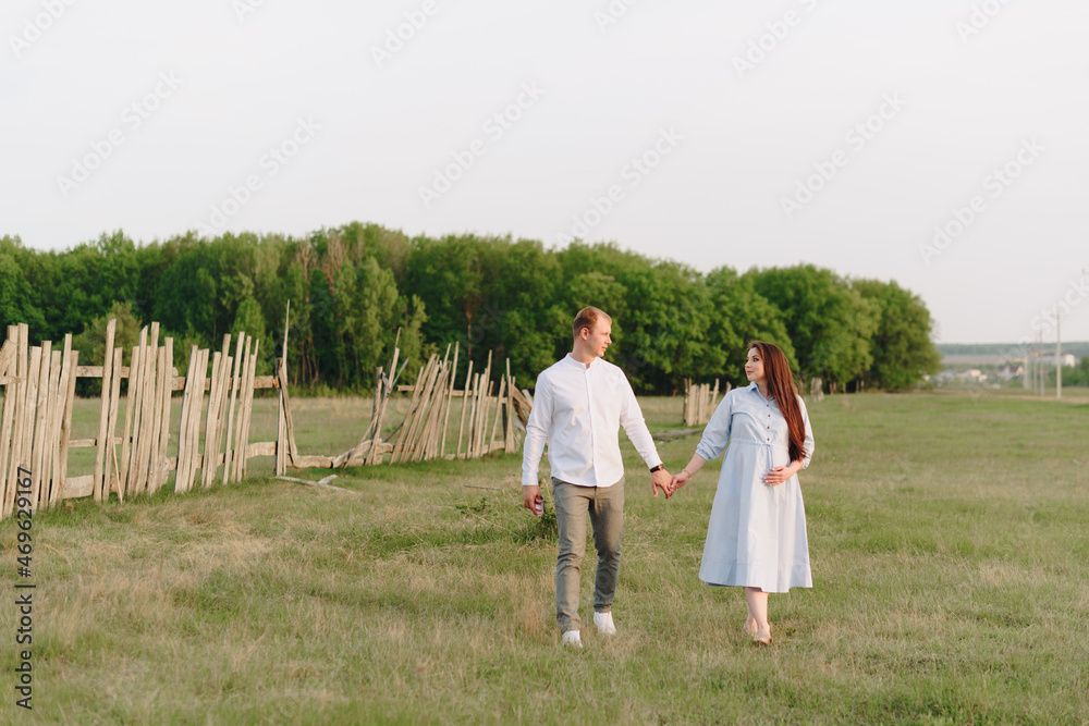 Young heterosexual pregnant couple in an outdoor park Young heterosexual pregnant couple in an outdoor park