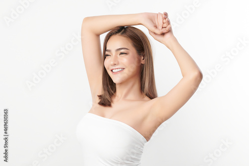 Beautiful Young Asian woman lifting hands up to show off clean and hygienic armpits or underarms on white background, Smooth armpit cleanliness and protection concept photo