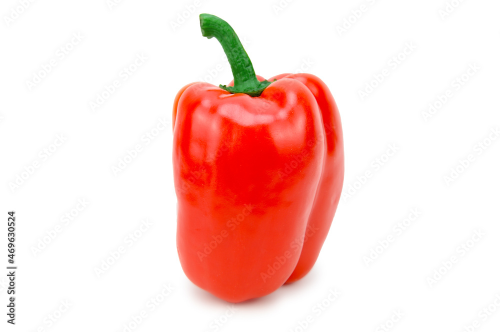 Red bell pepper fruit standing upright with a green pod on top Red bell pepper fruit standing upright with a green pod on top