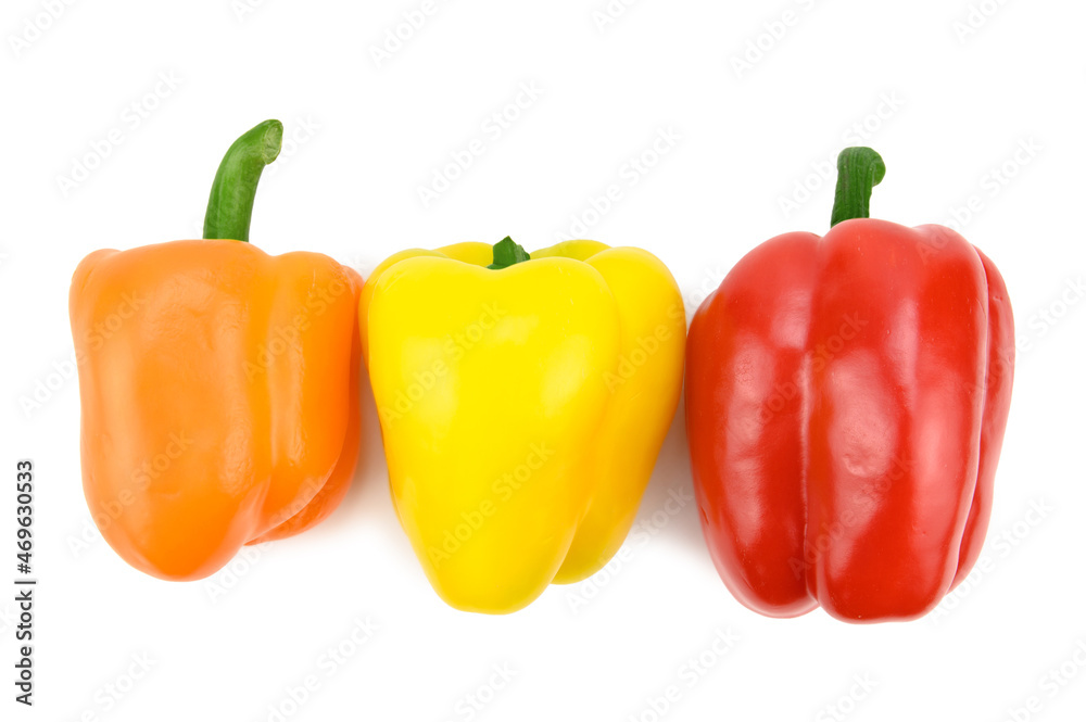 An overhead view of three multi-colored sweet bell peppers lying on their side An overhead view of three multi-colored sweet bell peppers lying on their side