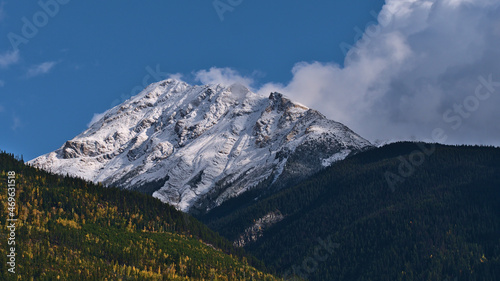 Beautiful view of rugged snow-capped mountain viewed from Robson Valley near McBride, British Columbia, Canada in autumn season with colorful forest.
