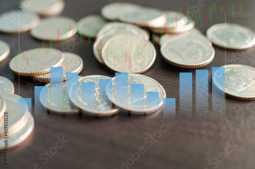 Stack coin with Graph sybols, candlestick chart stock market and bokeh background. planing earn cash investment from trade forex and saving money future for 2022 new year. finance and business. photo