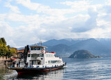 Ferry with passengers floats on Lake Como in Italy