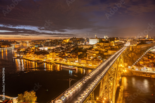 View of Porto with the river Douro and the Dom Luis I bridge at night © elxeneize