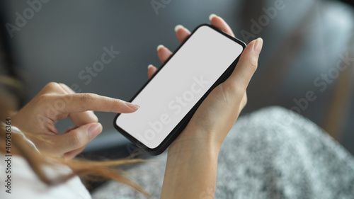 Close-up female hands using mobile applications via modern mobile phone